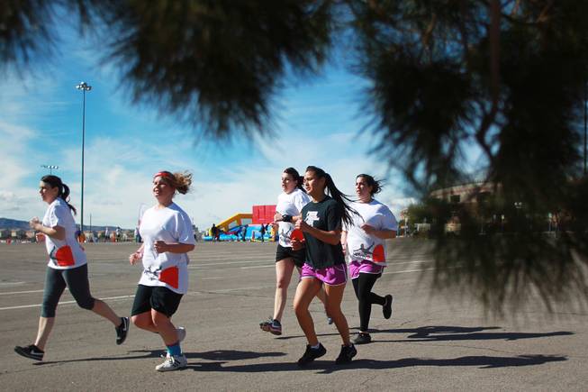 Participants jog during the Hit and Run 5k Saturday, March 1, 2014 at Sam Boyd Stadium. The Hit and Run 5k, a fun run with various obstacles to navigate, is being held or planned in two dozen cities across the country.